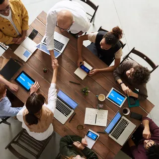 Editors and policy researchers reviewing documents around a meeting table
